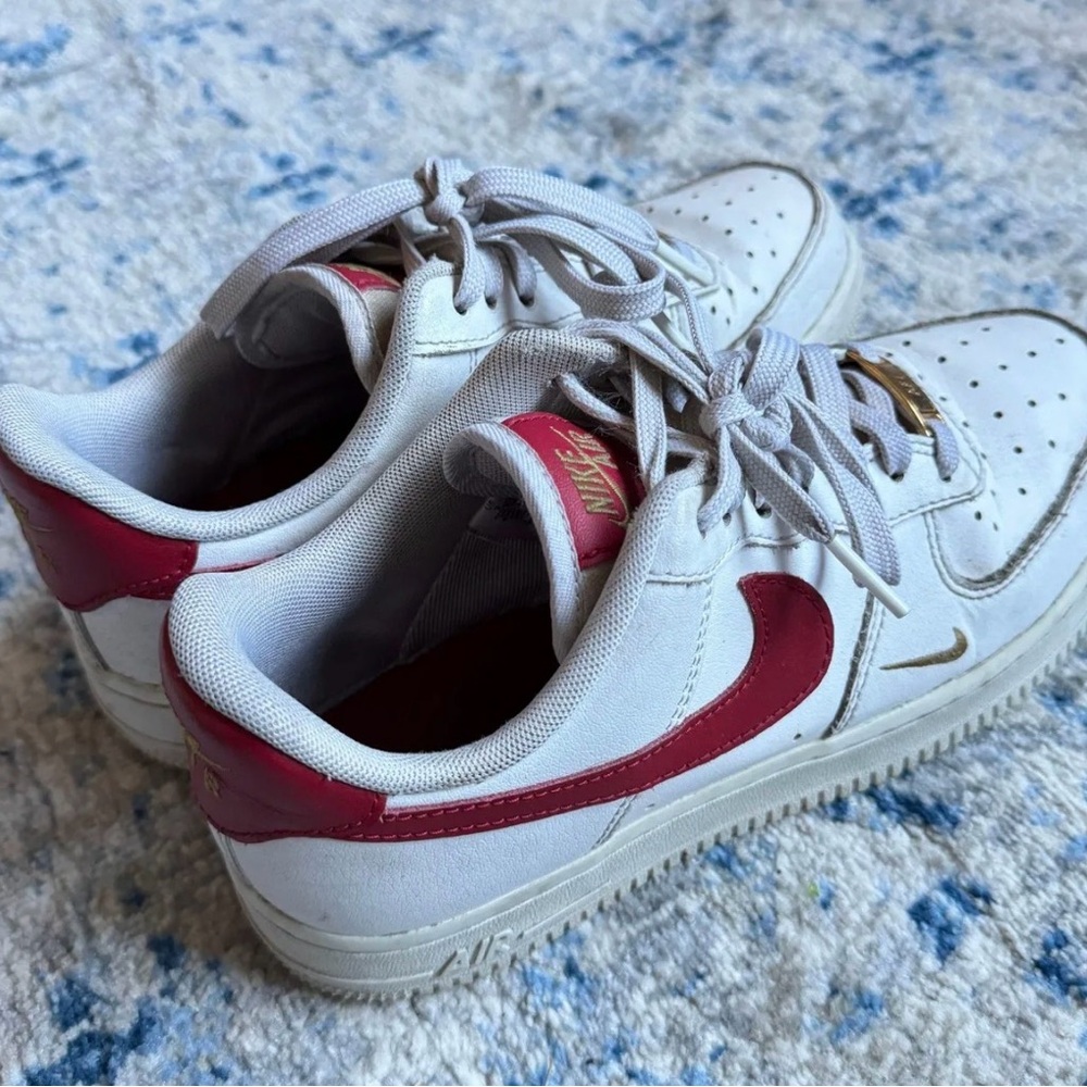 Nike Kids White Sneakers with Red Swoosh and Gold Detail